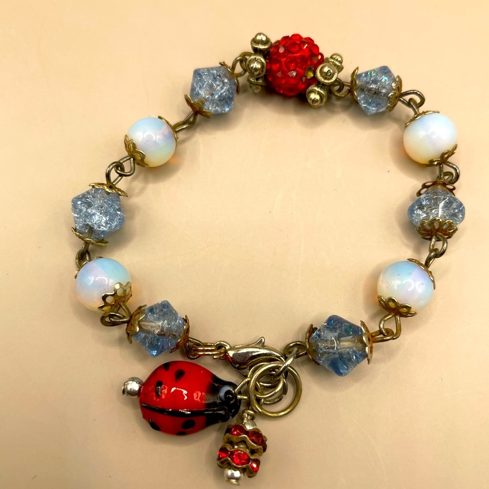 Silver blue and red bead and moonstone bead bracelet. With lady bug charm